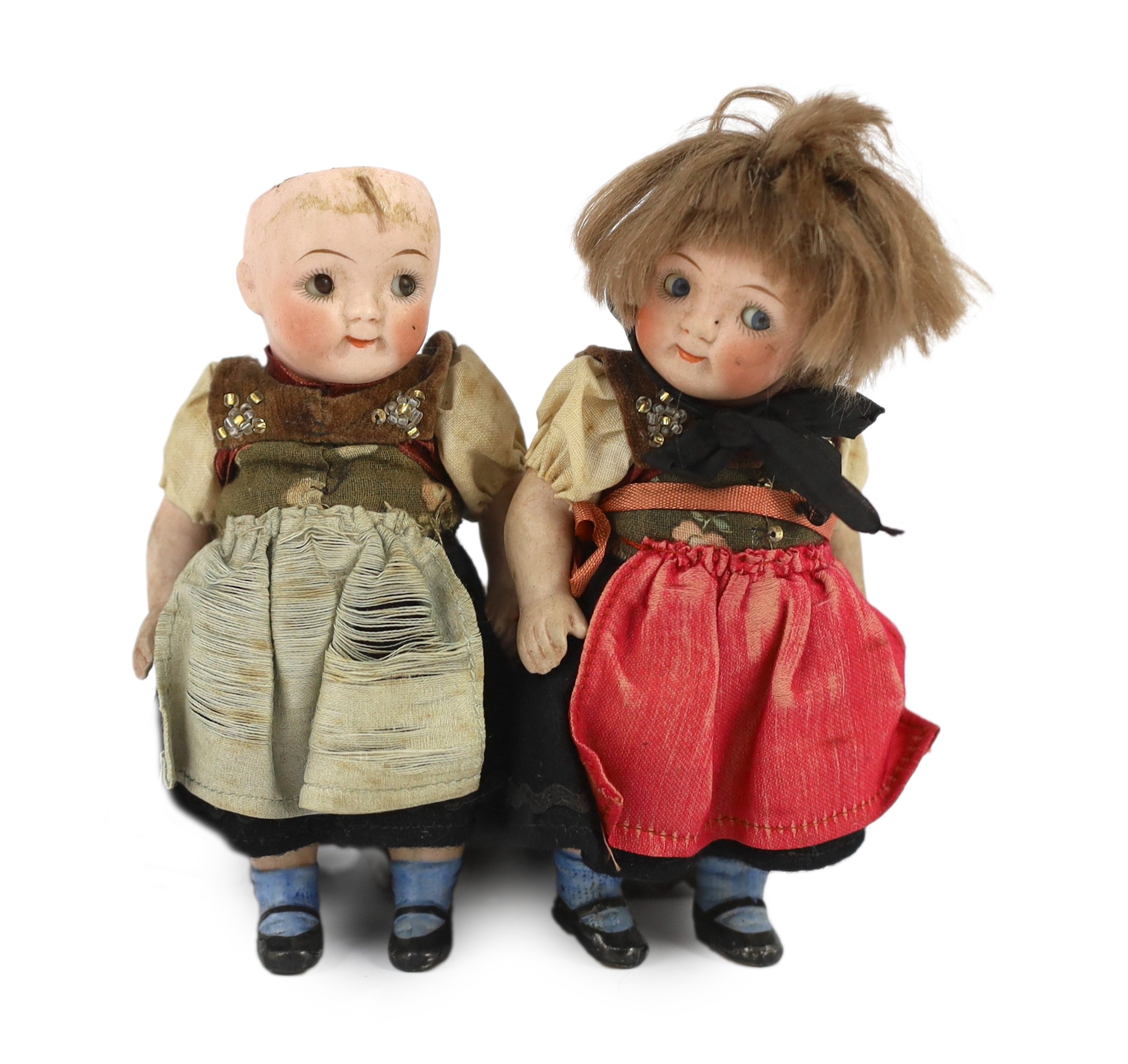 A pair of German all-bisque dolls with 'googly’ eyes, 14cm